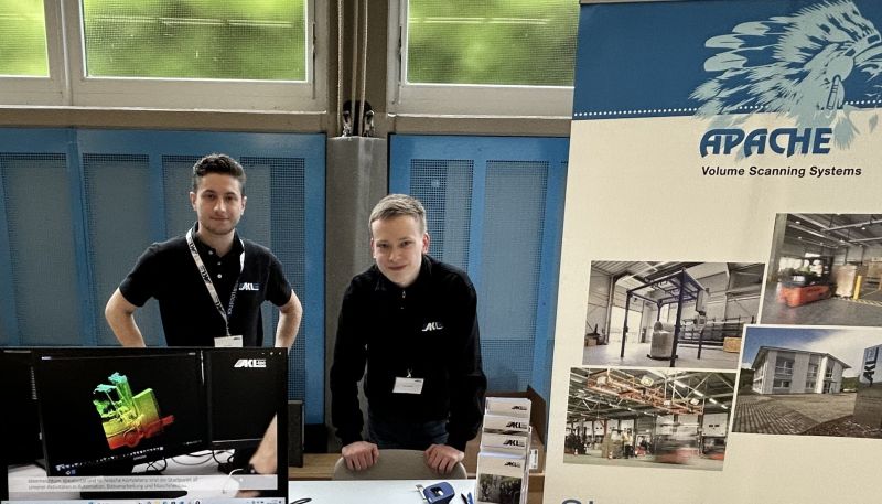 Two young men at a booth at the training fair in Daaden